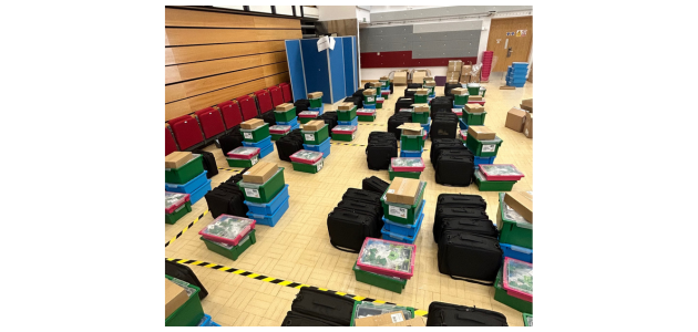 20 kits in a sports hall, ready to be loaded into vans and distributed across the Computing Hubs.